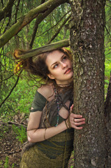 forest witch hugging a tree
