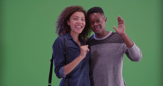 Millennial black man and woman pose for a portrait on green screen. On green screen to be keyed or composited. 