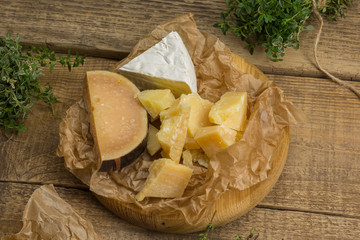 Delicious cheese on the wooden board.