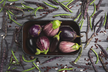 Raw organic vegetables on a gray wooden board