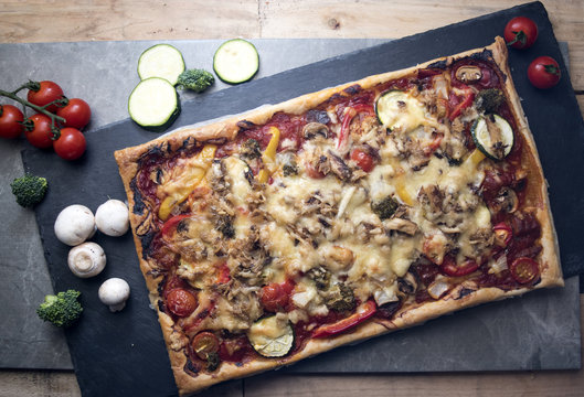 Cooked Pizza with Surrounding Vegetables
