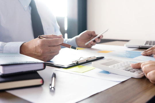 Businessman work with computer on table in office work with paper graph chart