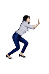 Beautiful businesswoman push something on studio