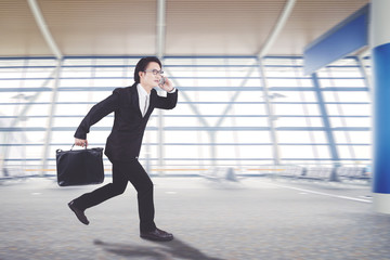 Asian businessman is running in the arrival hall