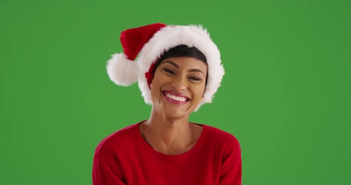 Close up of cheerful woman on Christmas morning smiling at camera on green screen. On green screen to be keyed or composited. 