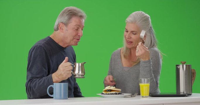 Lovely mid aged couple sharing breakfast together