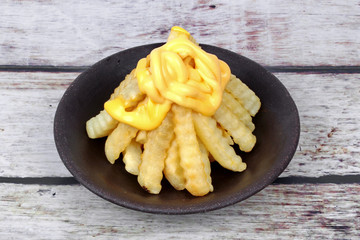 Volcano French fries as French fries topped with cheese arranged is like the volcano .