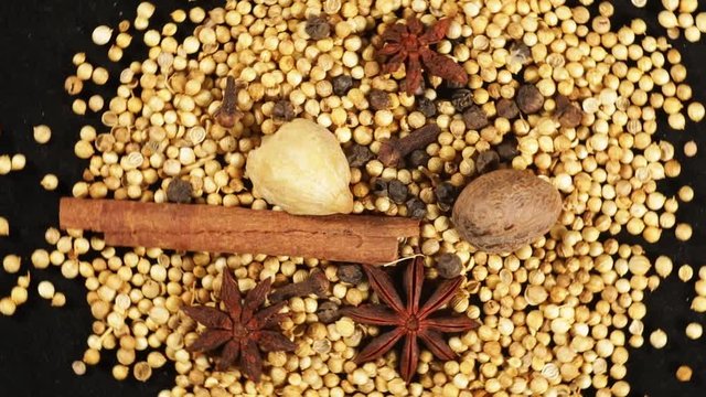 Video footage of spices and herbs on the table spinning on the table