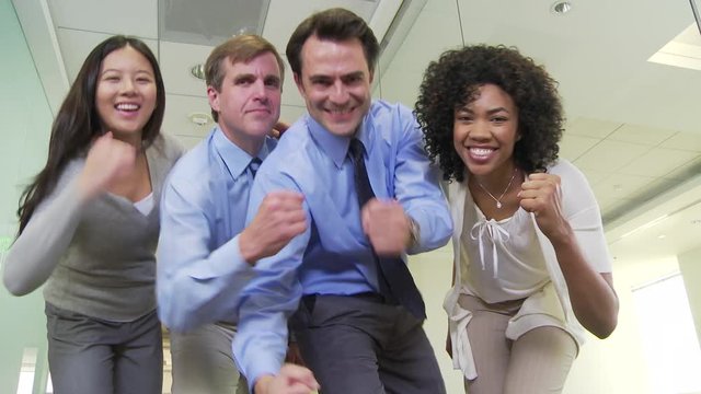 Business people joking in hallway