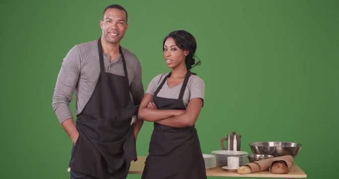 Portrait of African American man and woman small business owners on green screen. On green screen to be keyed or composited. 