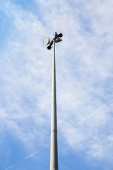 Fototapeta na wymiar Spot light pole on blue sky and clouds.