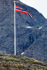 norwegian flag in rocky mountains