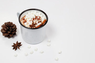 White cup of hot chocolate drink with marshmallows and cinnamon on white background. Winter time. Christmas holiday concept