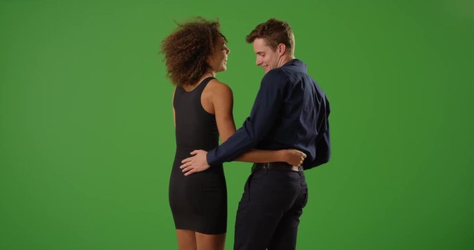 Lovely couple on a date dancing and embracing each other on green screen. On green screen to be keyed or composited. 