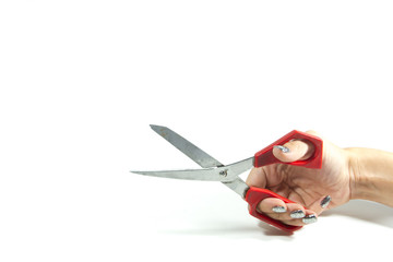 A hand holds on weight a red scissors a little open isolated on a white background