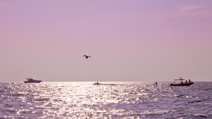 Professional camera drone flying on sea.