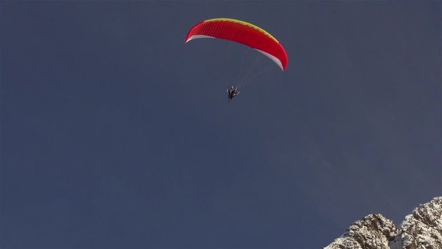 The Parachutist Plans In The Sky Near The Ridge