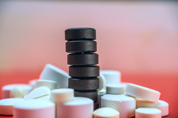 activated charcoal on the background of medicinal tablets