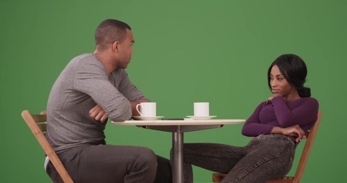 Couple after having an argument during vacation on green screen. On green screen to be keyed or composited. 