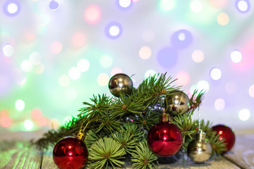 Christmas holiday background. Silver and red bauble hanging from a decorated on tree with bokeh, copy space