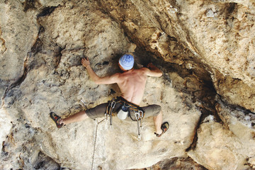 Rock climbing. A man climbs to the top.
