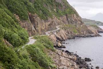 dirt road with curves on the sea towards Nyksund village in Norway