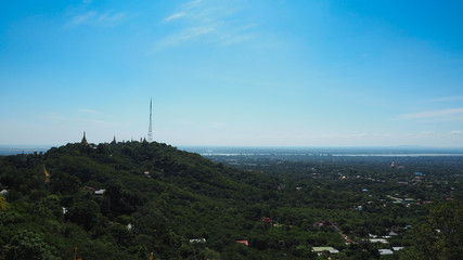 High angle view of multiple temples and pagodas on the mountains with Irrawaddy river in the background from sagaing hill, Sagaing region of Myanmar