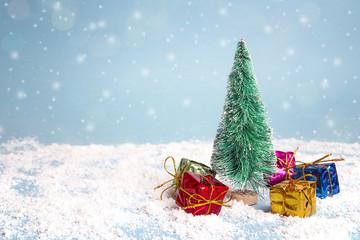 Miniature Christmas Tree with gift boxes. Copy space for text. Winter card.