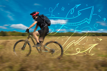 Young cyclist in with meadow background