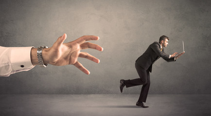 Businessman running from hand