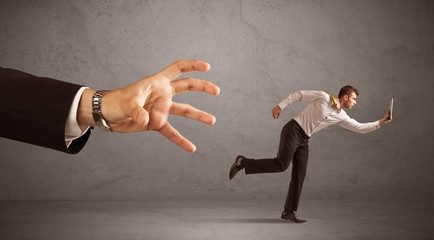Businessman running from hand