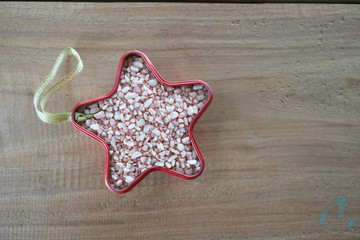 Fototapeta na wymiar potash fertilizer in red star shape on wooden table background.