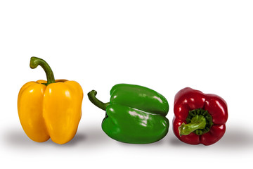 yellow, red and green peppers on a white background