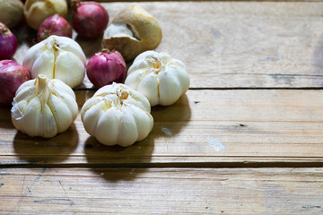 Artistic onion and garlic on wooden table