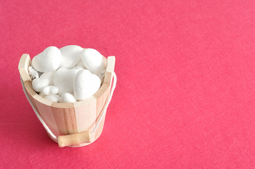 Valentines day. A wooden bucket filled with polystyrene hearts