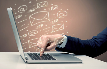 Sending client news letters on laptop