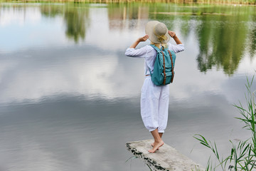 Young woman resting near lake