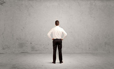 Businessman lost in empty urban space