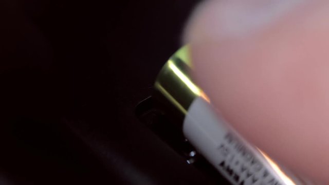 Insert new batteries into the remote control. The plus side of the battery is close-up. Macro. Closeup. Shallow depth of field

