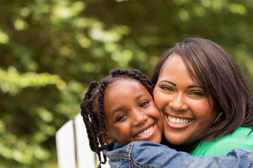 Happy African American mother and daughter.