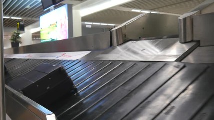 July 1st 2017. Schiphol Amsterdam Airport Baggage reclaim. Luggage falls on belt.