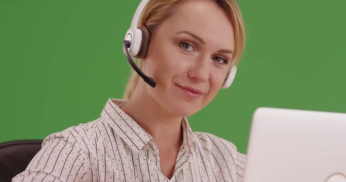 Friendly customer service representative on green screen. On green screen to be keyed or composited. 