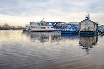 Fototapeta na wymiar Boats on the Dnieper in Kiev, Ukraine during a gray winter afternoon