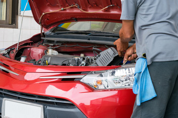 the worker repair a car at car maintenance service