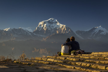 Couple in love enjoying view of Dhaulagiri from Poon Hill. Himalaya Mountains, Nepal.