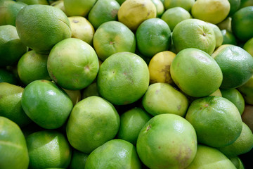 green grapefruit in the market stalls