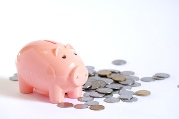Pink Piggy bank with stacked coins