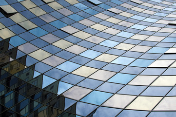 Perspective view of the modern glass building facade with reflections on the windows. Architectural...