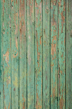 Old green and brown wood with peeling paint and natural patterns nice for background
