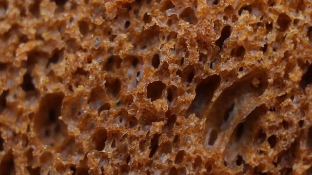 Black bread background, macro shot